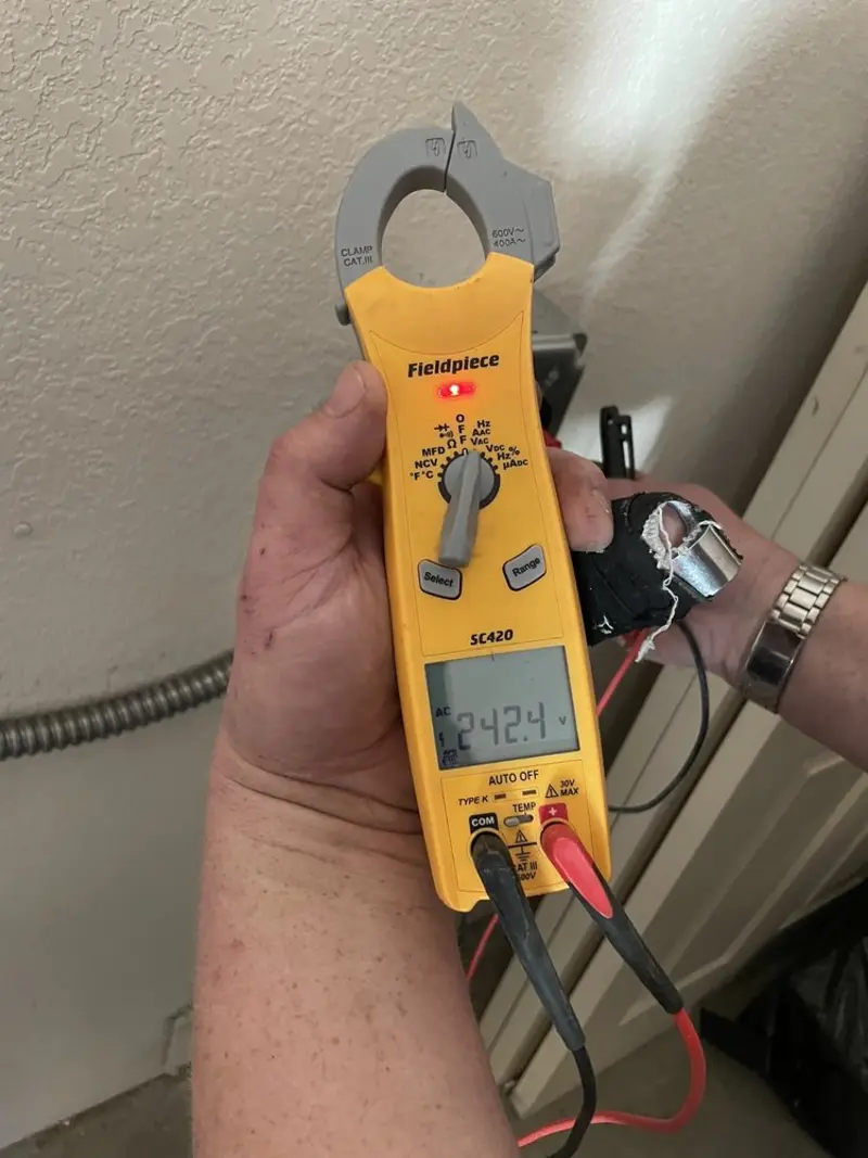 Voltage testing with clamp meter during Aluminum Wiring Replacement in Orange